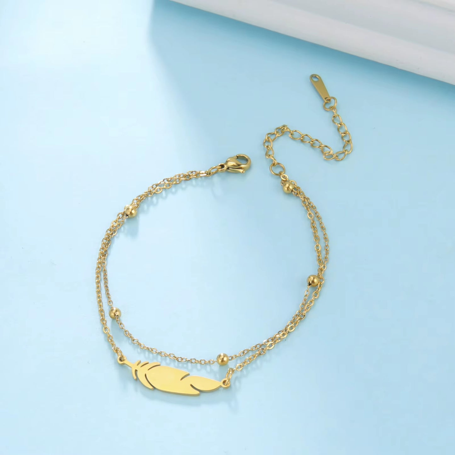 Chaines de cheville plume en acier inoxydable couleur or et argent
